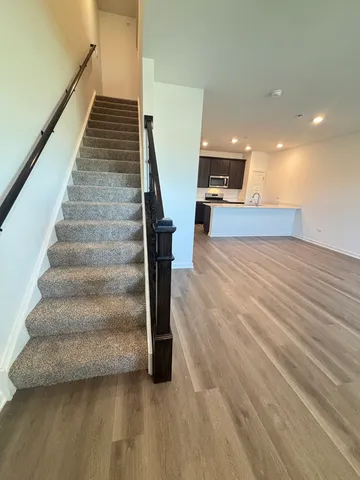 a view of entryway and hall with wooden floor