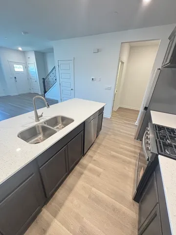a kitchen with a sink and a refrigerator