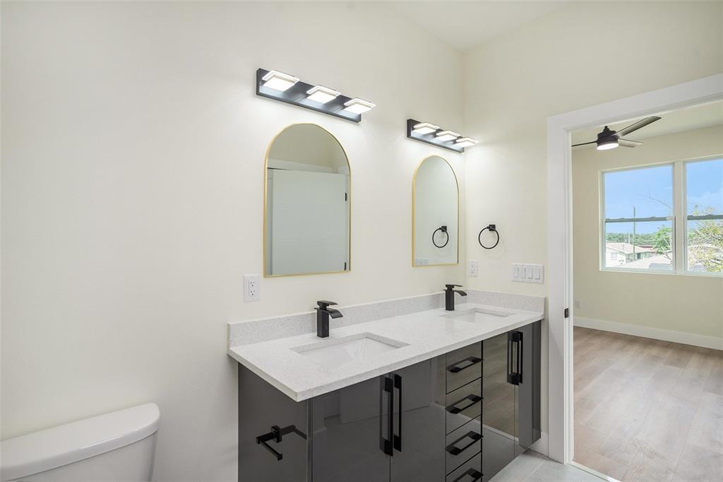3612 Temple Street Tampa, FL 33619 - Photo 16 of 26 a bathroom with a double vanity sink and a mirror