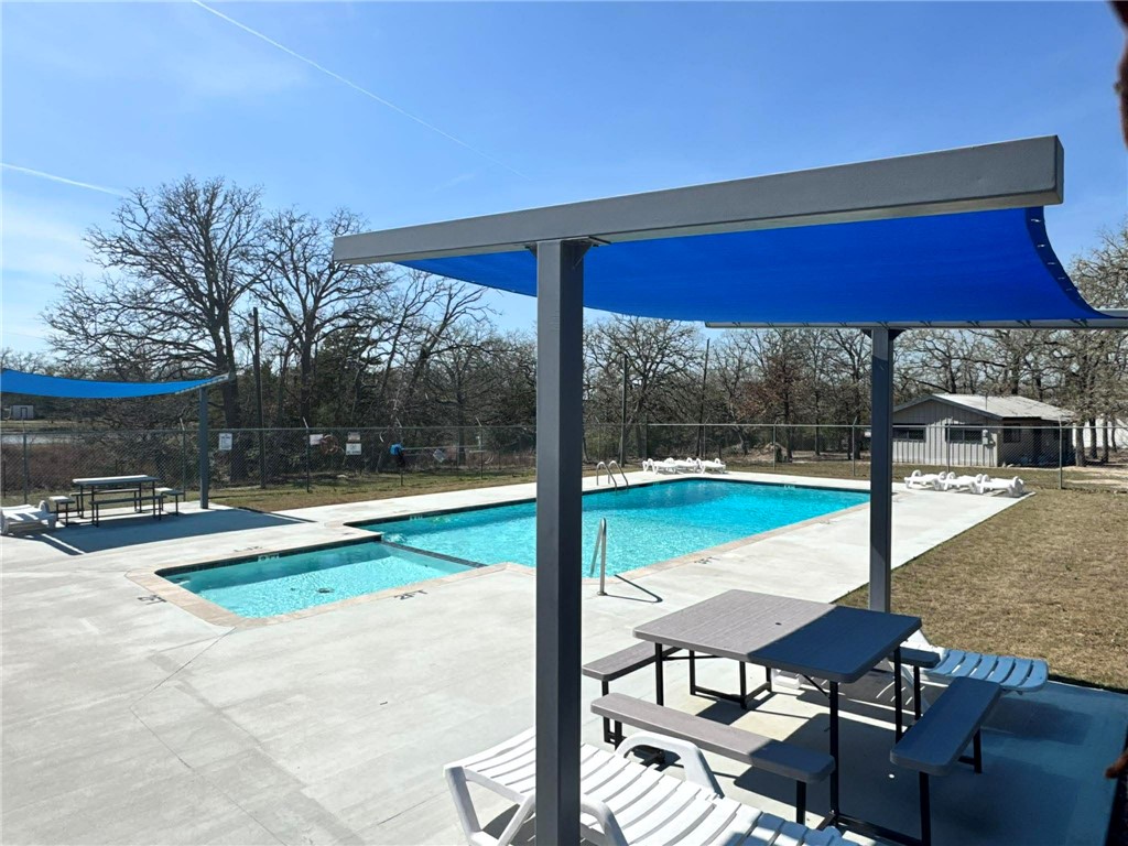 100 Patriots Place Somerville, TX 77879 - Photo 26 of 28 a view of swimming pool with a table and chairs under an umbrella