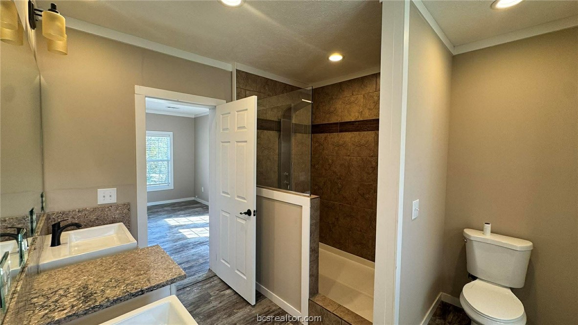 100 Patriots Place Somerville, TX 77879 - Photo 5 of 28 a bathroom with a granite countertop sink and a mirror