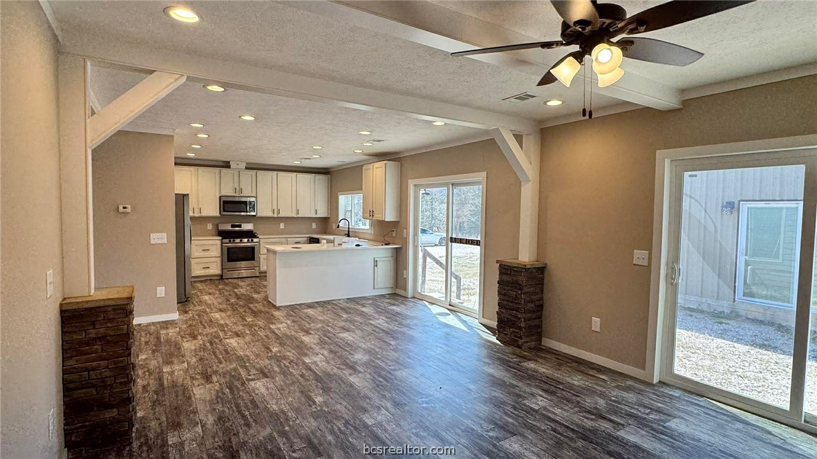 100 Patriots Place Somerville, TX 77879 - Photo 7 of 28 a kitchen with kitchen island white cabinets and refrigerator