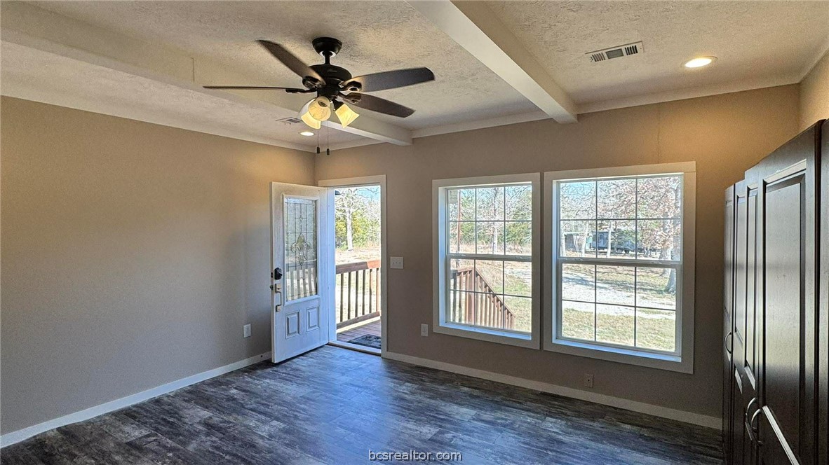 100 Patriots Place Somerville, TX 77879 - Photo 9 of 28 a view of an empty room with wooden floor and a window