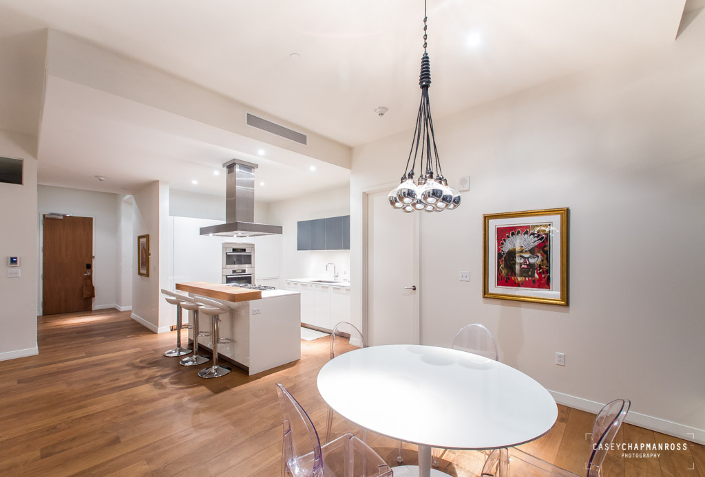 210 Lavaca Street, Unit 1910 Austin, TX 78701 - Photo 11 of 40 a view of a dining room with furniture wooden floor and a chandelier