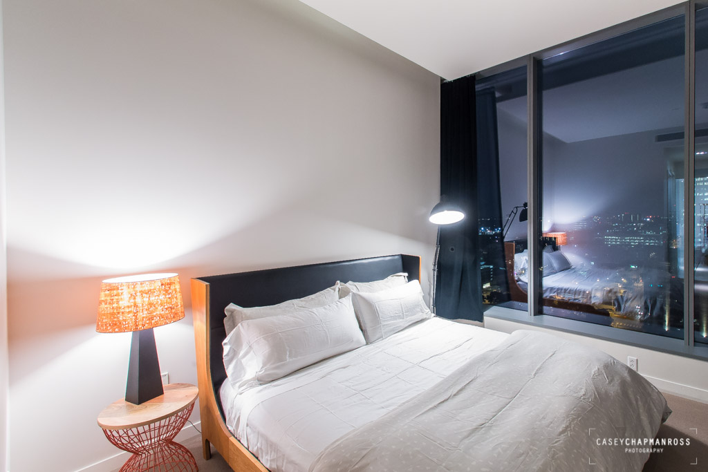 210 Lavaca Street, Unit 1910 Austin, TX 78701 - Photo 27 of 40 a bedroom with a bed and a mirror