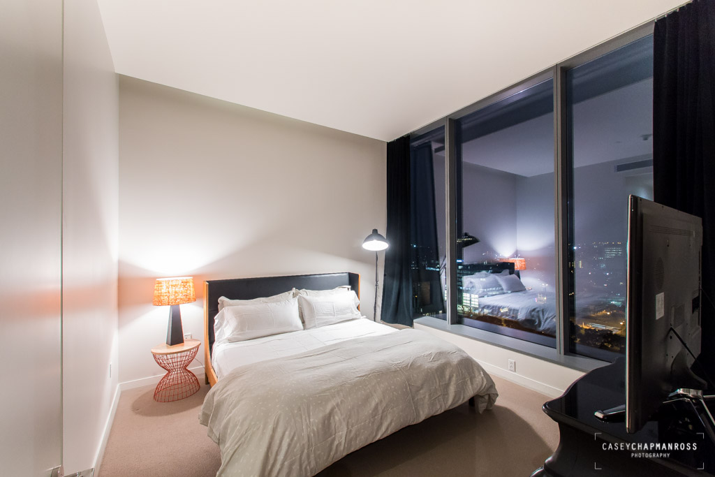 210 Lavaca Street, Unit 1910 Austin, TX 78701 - Photo 28 of 40 a bedroom with a bed a mirror and lamp