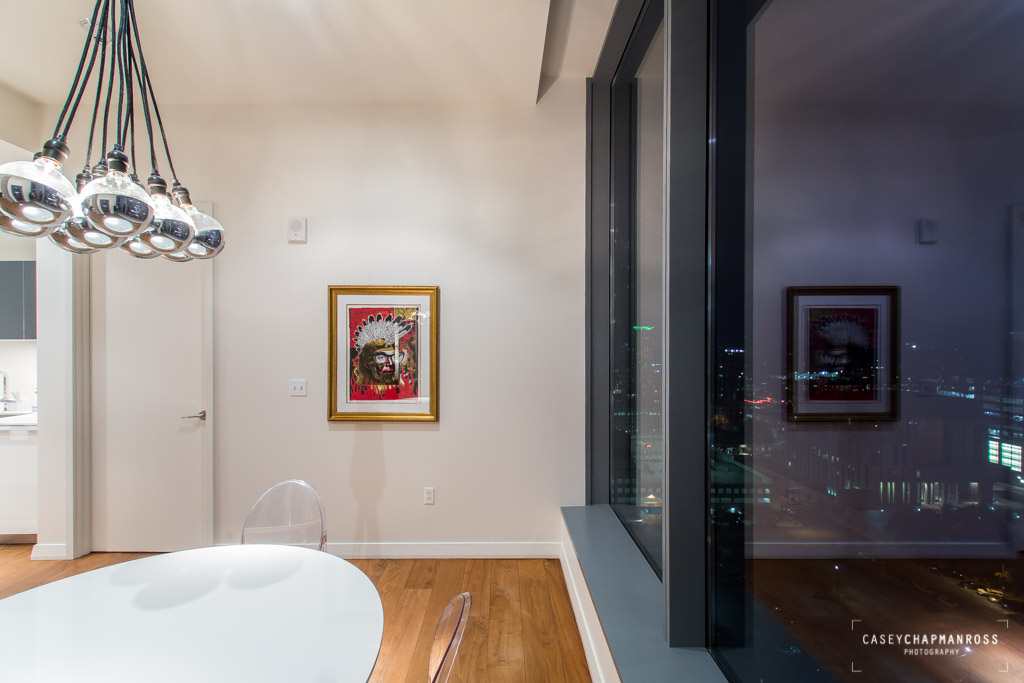 210 Lavaca Street, Unit 1910 Austin, TX 78701 - Photo 29 of 40 a bedroom with a bed and a chandelier