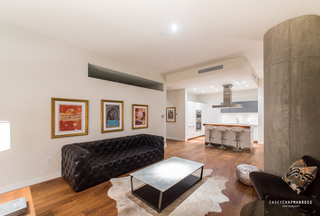 210 Lavaca Street, Unit 1910 Austin, TX 78701 - Photo 3 of 40 a living room with furniture and a kitchen view