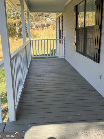 an empty room with a ceiling fan and window