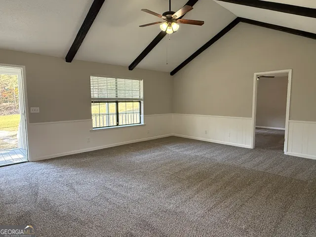 a view of a hallway with wooden floor and windows