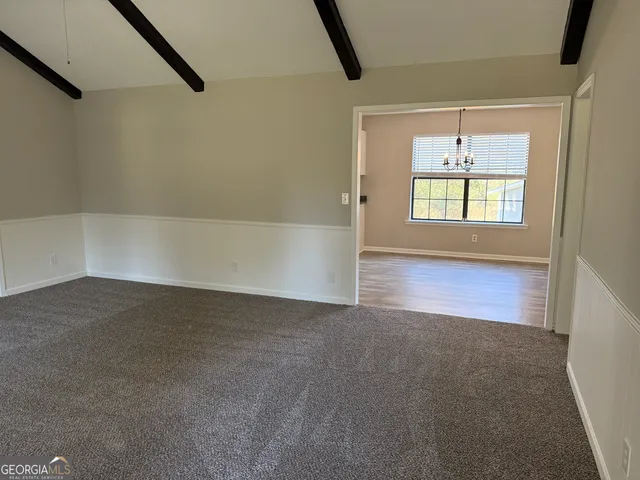 a kitchen with granite countertop white cabinets and a sink