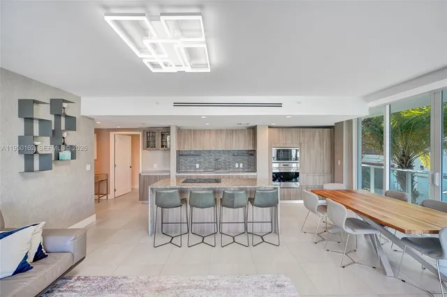 a large white kitchen with a table and chairs