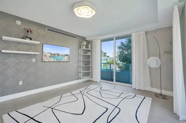 a view of a bedroom with wooden floor and large window