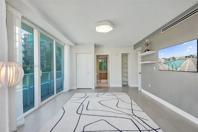 a bathroom with a granite countertop sink toilet and painting on the wall
