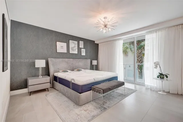 a bedroom with a bed a table and painting