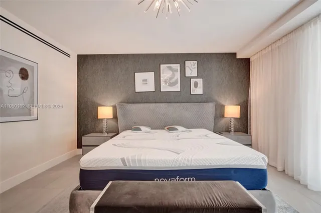 a bedroom with a bed and a chandelier