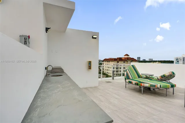 a balcony with furniture and a potted plant
