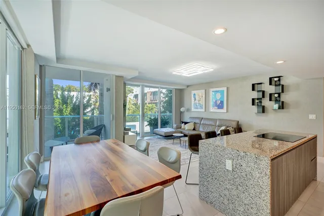 a kitchen with a table chairs refrigerator and cabinets