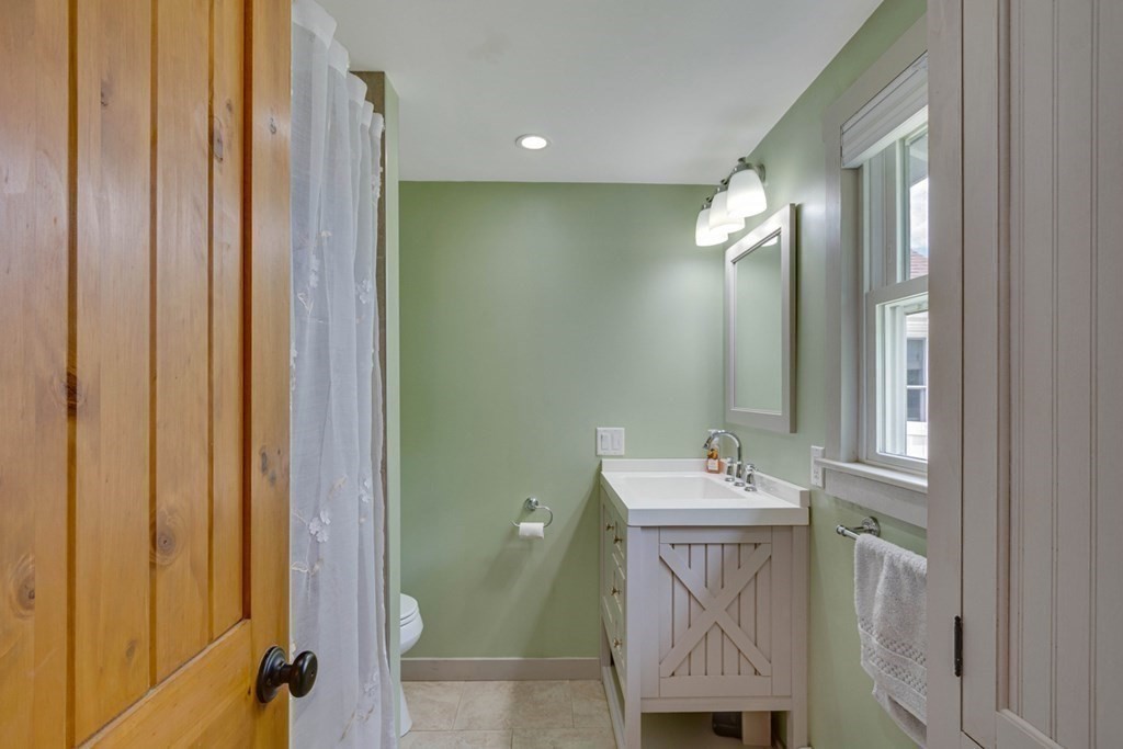 16 Milford Avenue Natick, MA 01760 - Photo 18 of 34 a bathroom with a sink vanity and a mirror