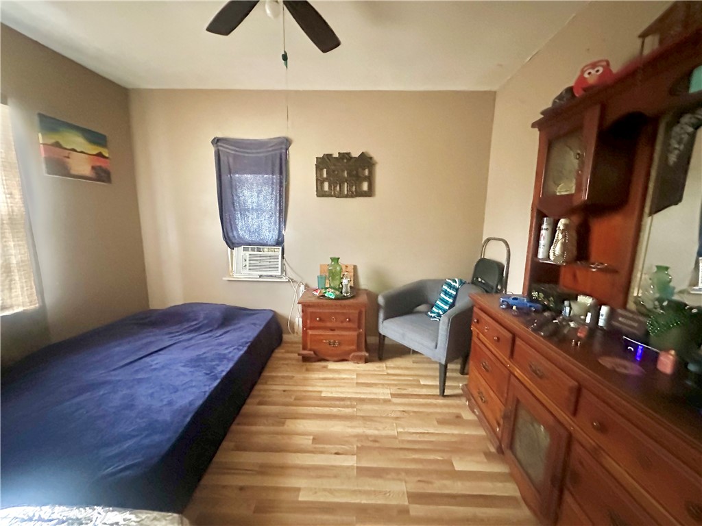 801 Ruben Chavez Road Robstown, TX 78380 - Photo 8 of 18 a bedroom with bed and wooden floor