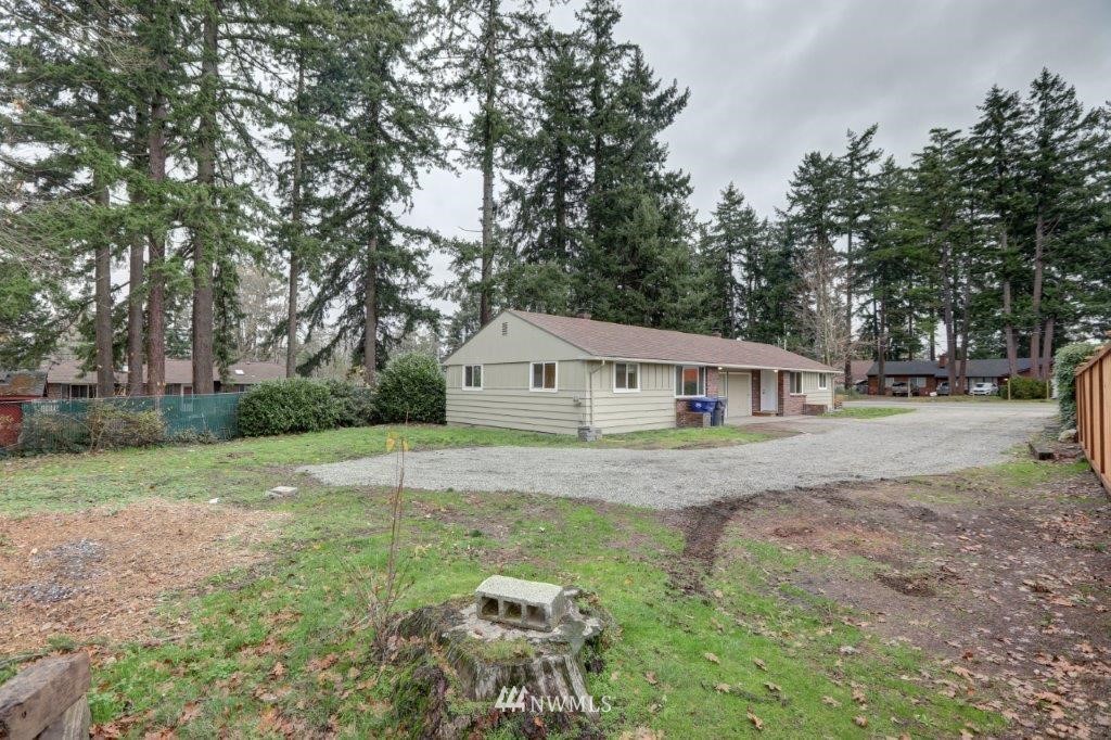 8818 Custer Road Southwest Lakewood, WA 98499 - Photo 1 of 10 a view of a house with yard and a garden