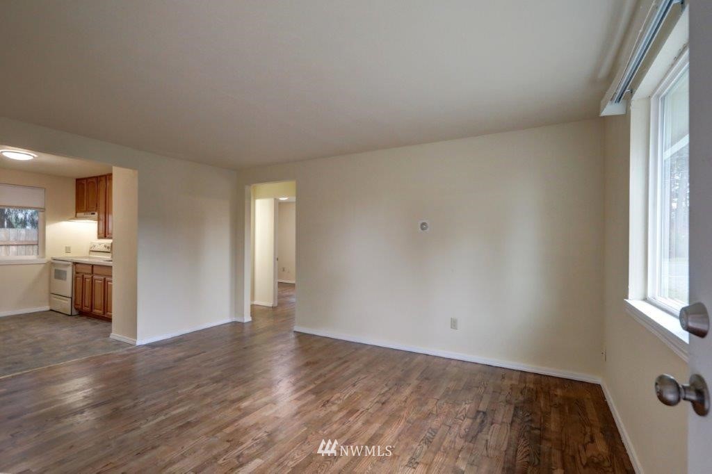 8818 Custer Road Southwest Lakewood, WA 98499 - Photo 5 of 10 wooden floor in an empty room with a window