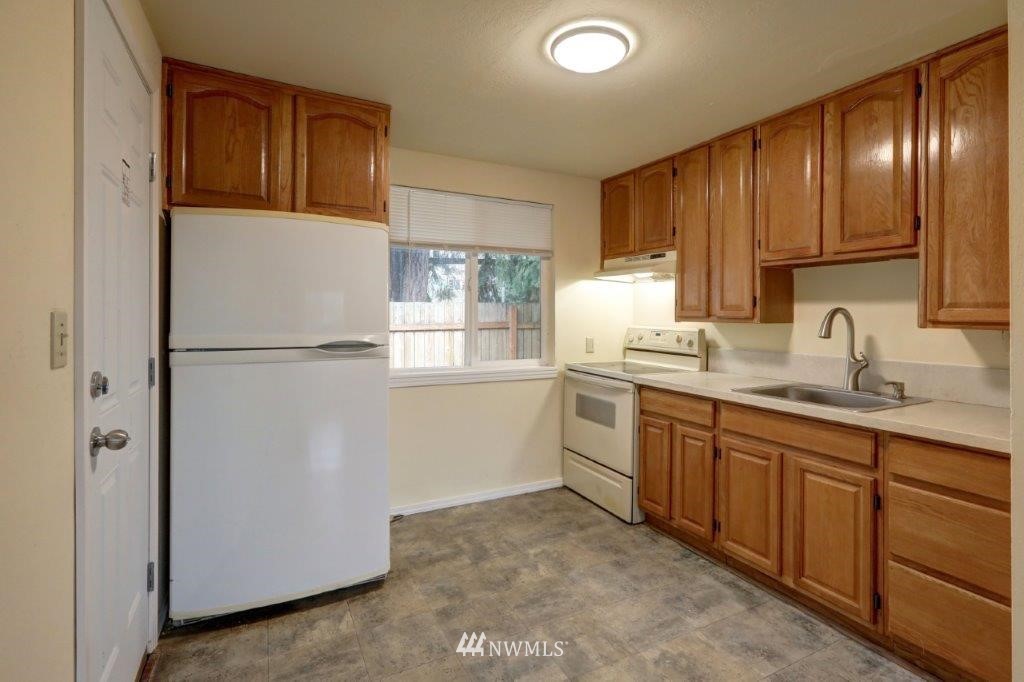 8818 Custer Road Southwest Lakewood, WA 98499 - Photo 7 of 10 a kitchen with a sink refrigerator and cabinets