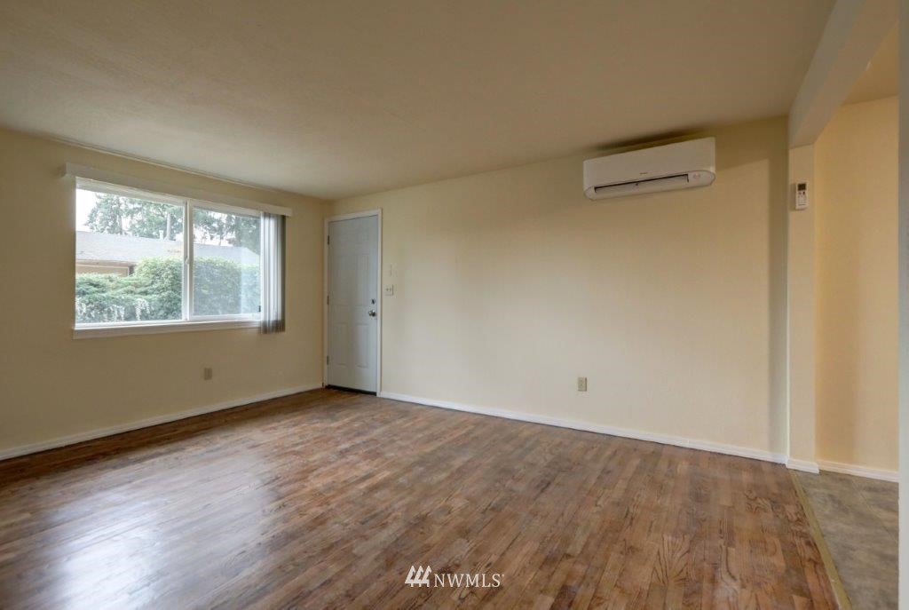 8818 Custer Road Southwest Lakewood, WA 98499 - Photo 9 of 10 an empty room with wooden floor and windows