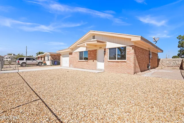 a view of a house with a snow on the road