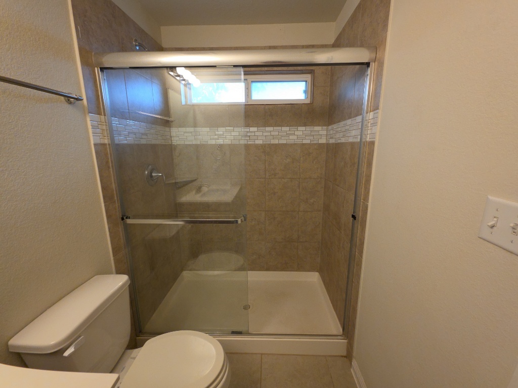 18009 Malnati Drive Pflugerville, TX 78660 - Photo 13 of 22 a bathroom with a toilet and a shower