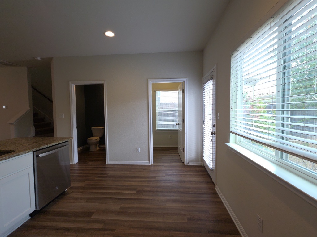 18009 Malnati Drive Pflugerville, TX 78660 - Photo 5 of 22 a view of a kitchen with wooden floor and a window
