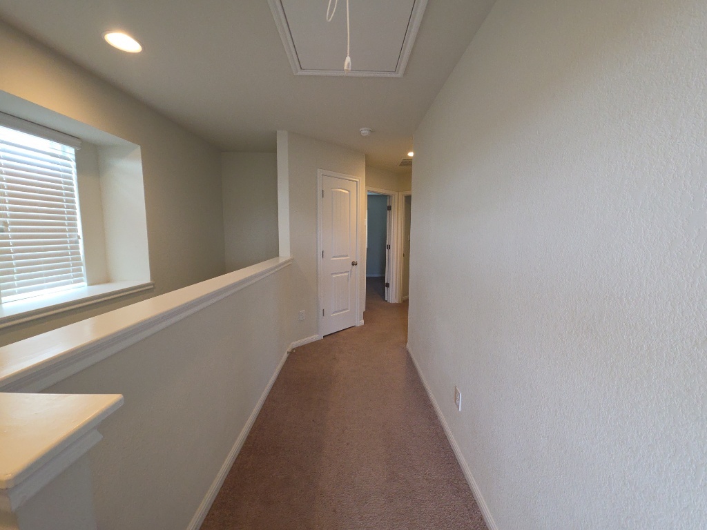 18009 Malnati Drive Pflugerville, TX 78660 - Photo 9 of 22 a view of a hallway with closet