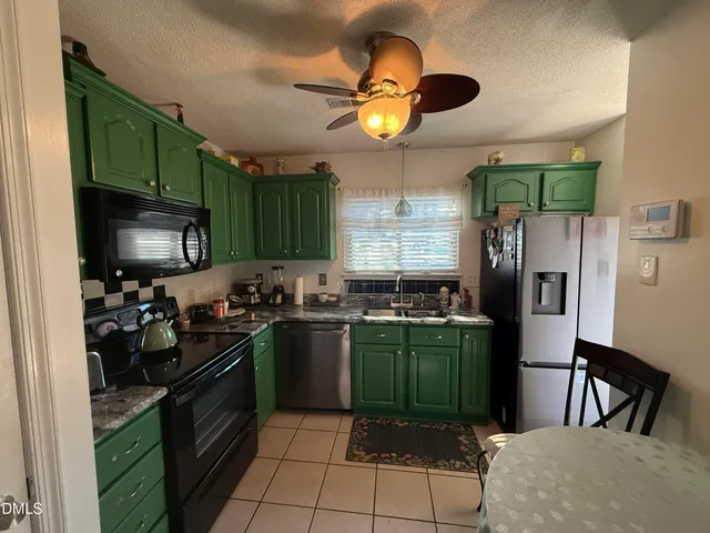 a kitchen with cabinets and steel stainless steel appliances