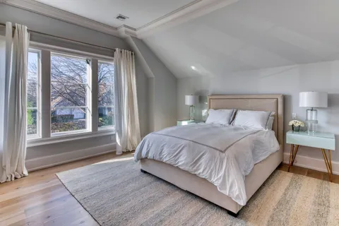 a bedroom with a large bed and a large window