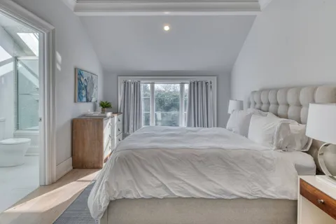 a bedroom with a bed and a large window