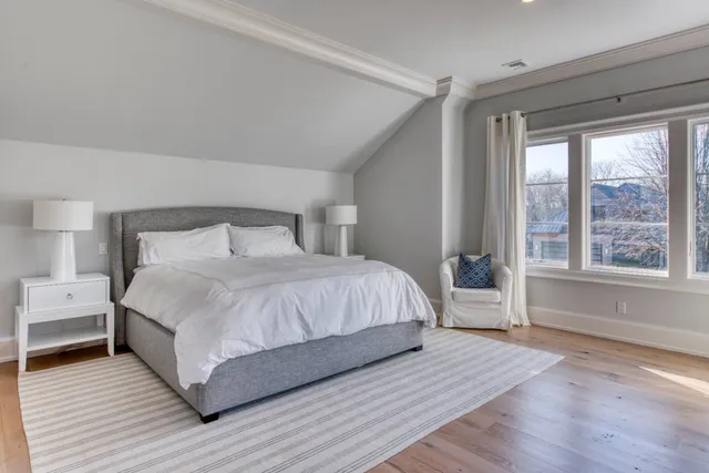 a bedroom with a large bed and a large window