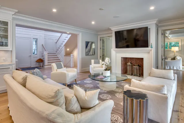 a living room with furniture a fireplace and a flat screen tv