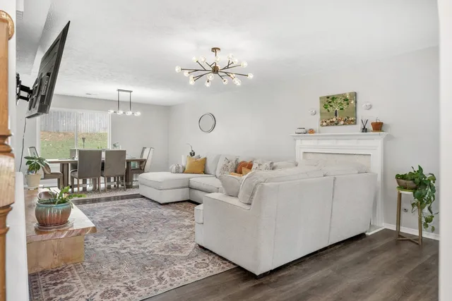 a living room with furniture and a chandelier
