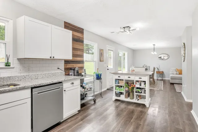 a kitchen with a table chairs stove and cabinets