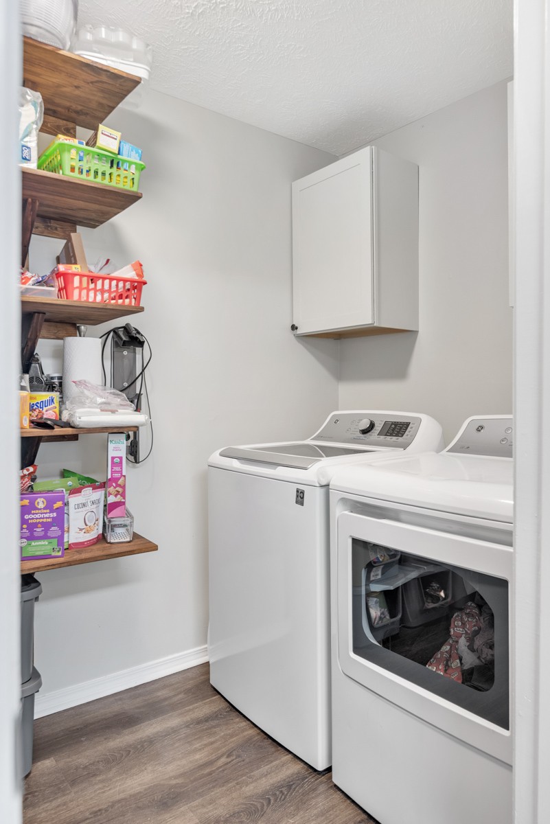 7226 Hidden Lake Drive Fairview, TN 37062 - Photo 18 of 54 a utility room with fridge and wooden floor