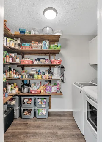 a view of kitchen with food items with wooden floor