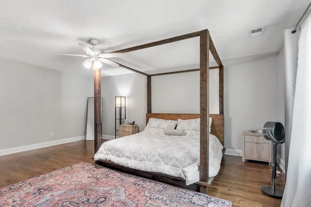 a bedroom with a bed and a mirror