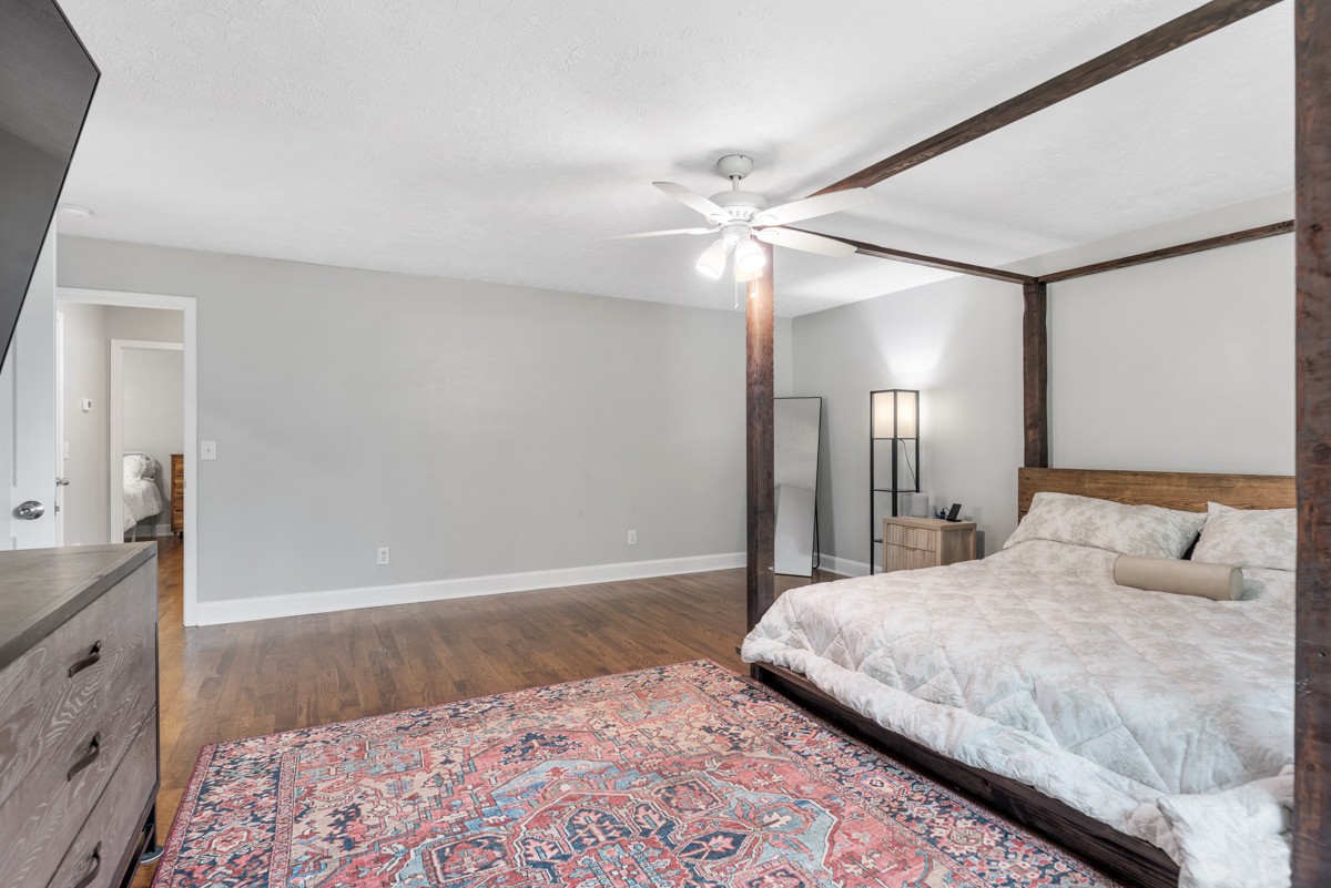 7226 Hidden Lake Drive Fairview, TN 37062 - Photo 23 of 54 a bedroom with a large bed and a chandelier