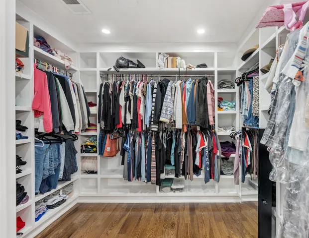 a view of walk in closet with clothes