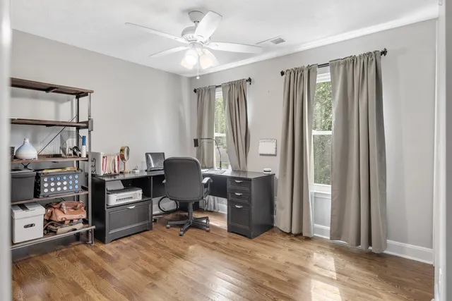 a view of a workspace with furniture and a window
