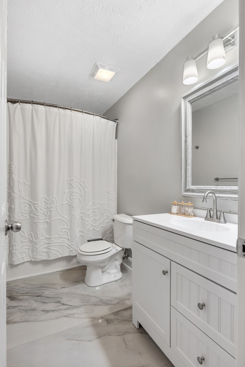 7226 Hidden Lake Drive Fairview, TN 37062 - Photo 31 of 54 a bathroom with a double vanity sink toilet and a mirror