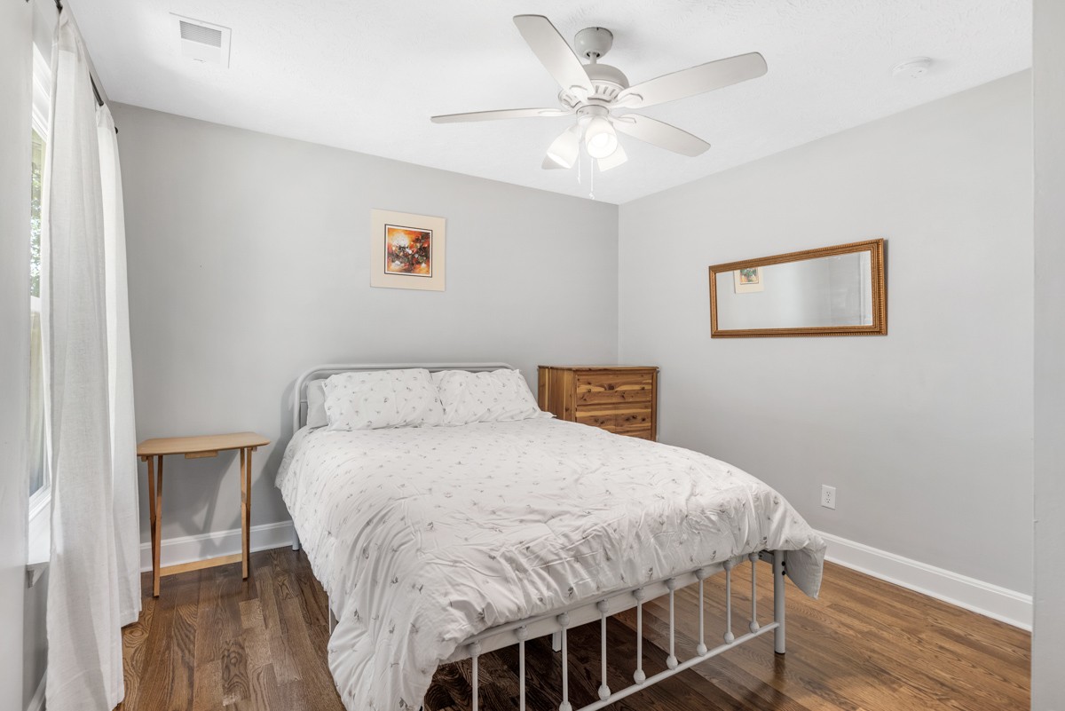 7226 Hidden Lake Drive Fairview, TN 37062 - Photo 32 of 54 a bedroom with a bed and wooden floor