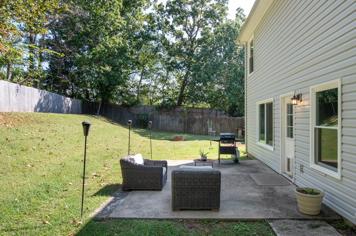 7226 Hidden Lake Drive Fairview, TN 37062 - Photo 39 of 54 a view of a patio with couches chairs and a fire pit
