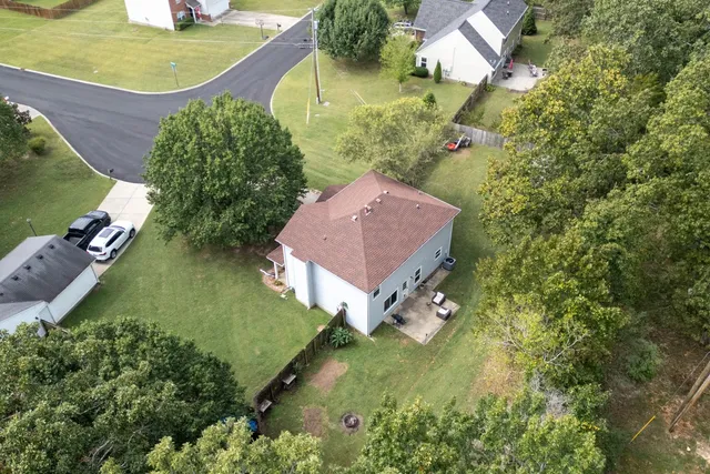 an aerial view of a house with a yard and lake view