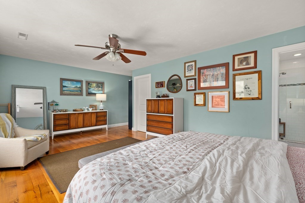 4 Mentas Circle Woburn, MA 01801 - Photo 19 of 41 a bedroom with a bed and a chandelier